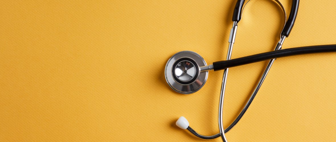 Stethoscope on a yellow background with space for text Stethoscope on a yellow background with space for text