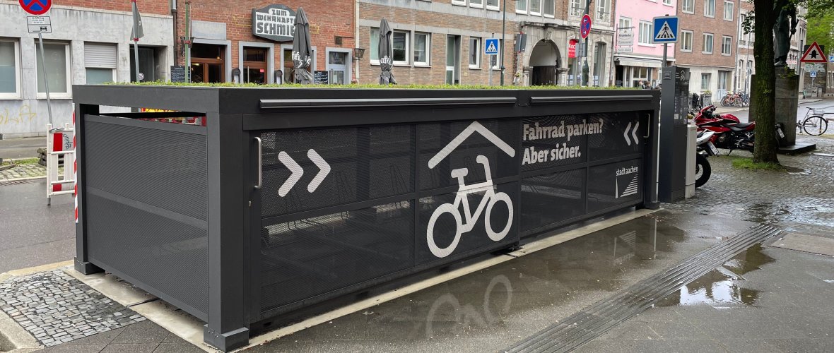 a gray box in which several bicycles can be parked and locked up