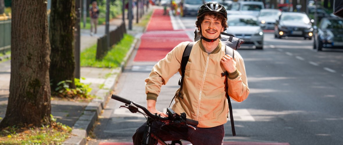 A cyclist on the road on a bicycle priority route