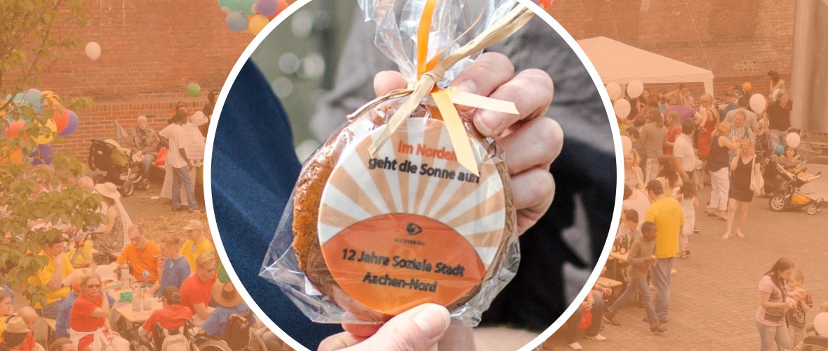 A photo collage shows a wrapped cookie as a promotional gift from Aachen Nord. In the background, a well-attended street festival can be seen.