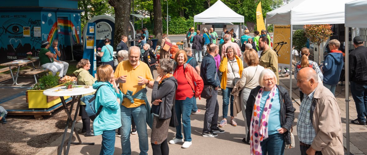Visitors to the neighborhood festival chat with each other
