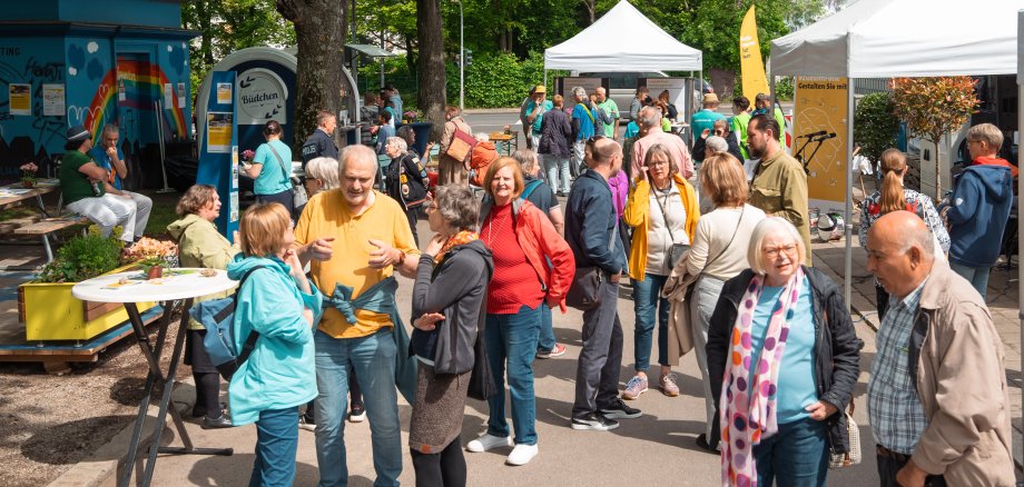 Visitors to the neighborhood festival chat with each other