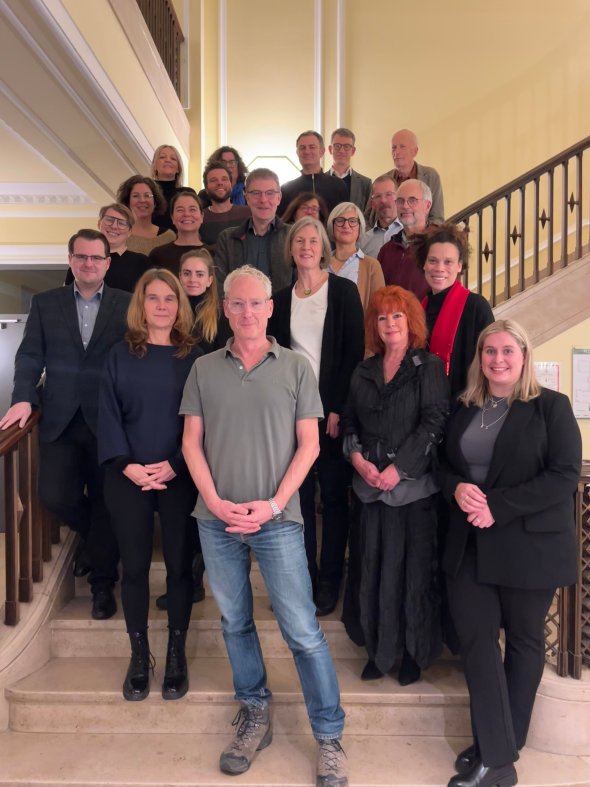 All members of the Forest Steering Group present stand on a staircase for a photo