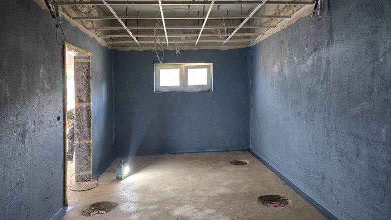 Waterproofing is applied before tiling work in ladies' showers.