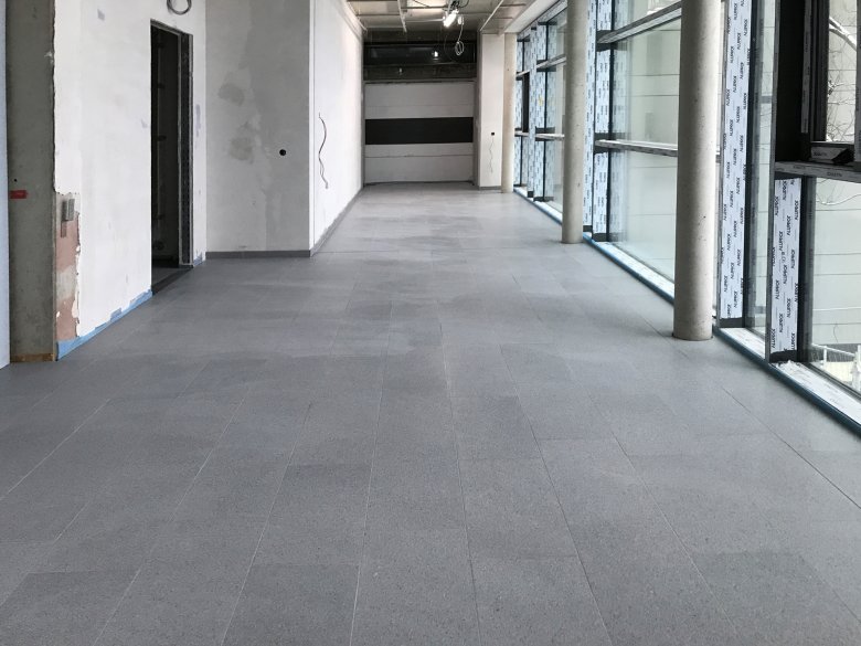 The concrete block work in the connecting corridor has been completed. The other flooring work is in progress.