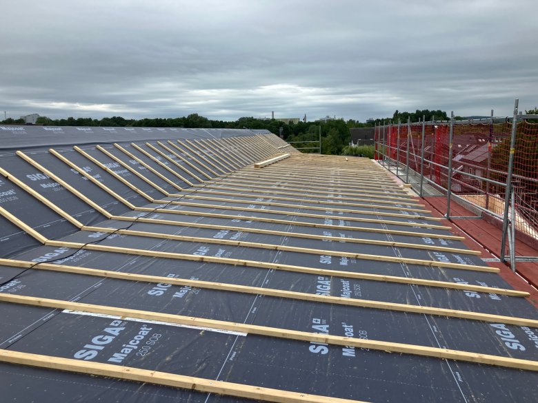 Roof waterproofing and battens are installed.