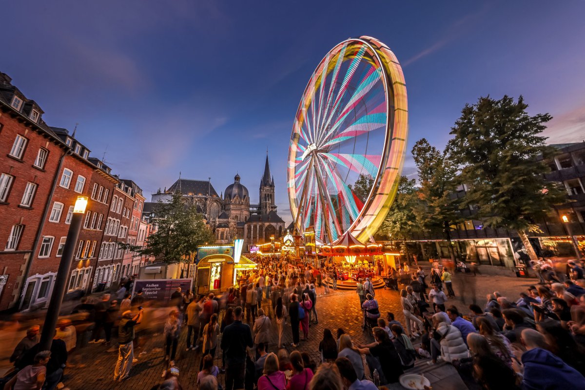 The illuminated Ferris wheel at dusk.