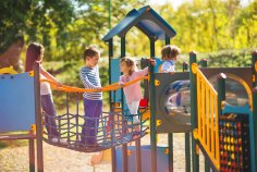 Playground A small group of children are having fun on the climbing frame and chatting.