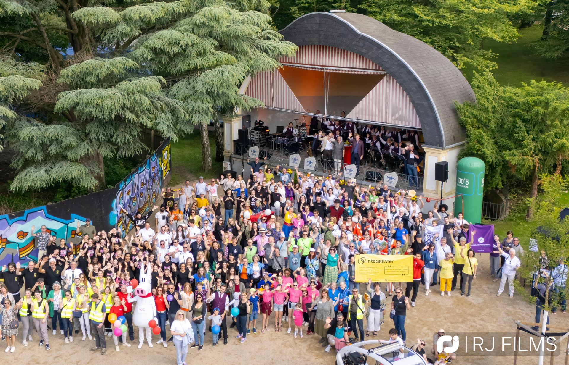Aerial view: Crowd in front of the stage in the city park.