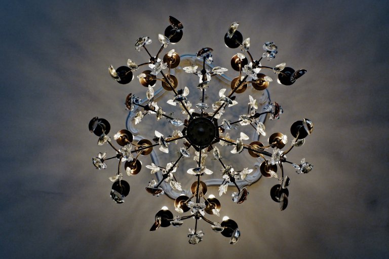 Parisian chandelier made of gilded wrought iron with rich glass prisms