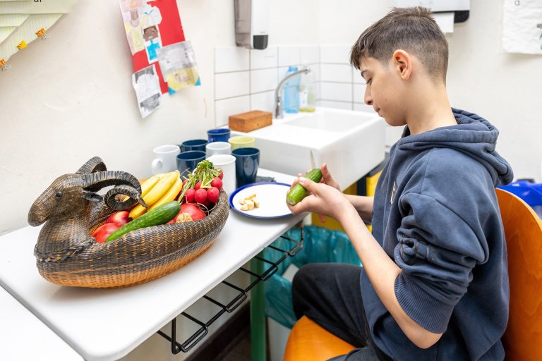 ...-20250402-... Fresh on the table: 12-year-old Mohammad concentrates on cutting fruit and vegetables
