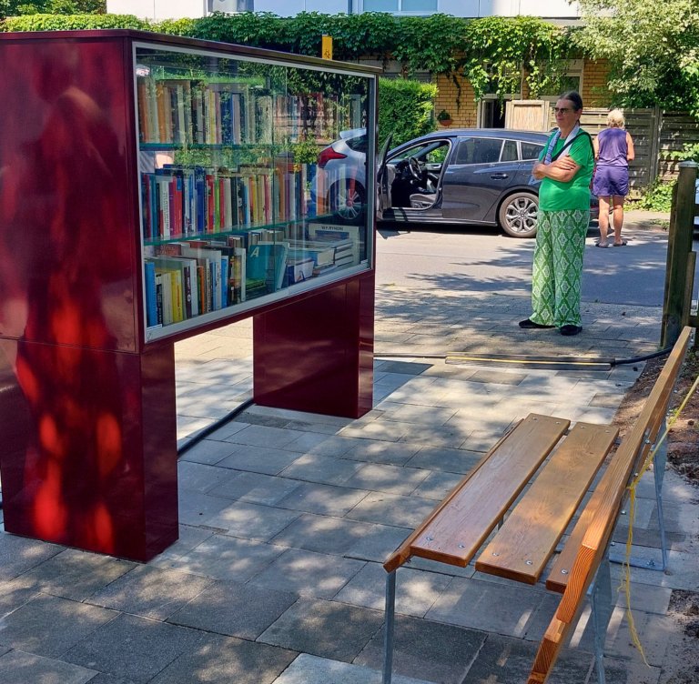 A bookcase and a bench in a square