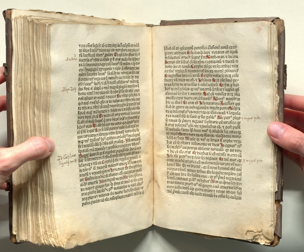 A historical book with visible signs of wear and damage
