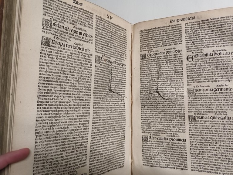 A historical book with visible signs of wear and damage