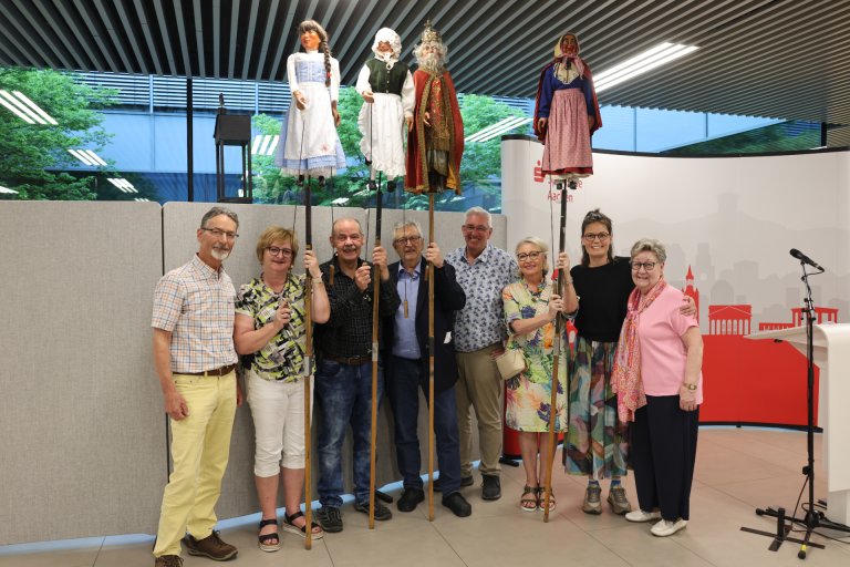 A group of people with puppets from a puppet theater