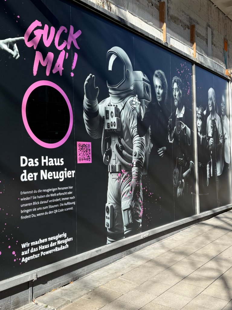 A pasted shop window with a peephole and an astronaut on a black background