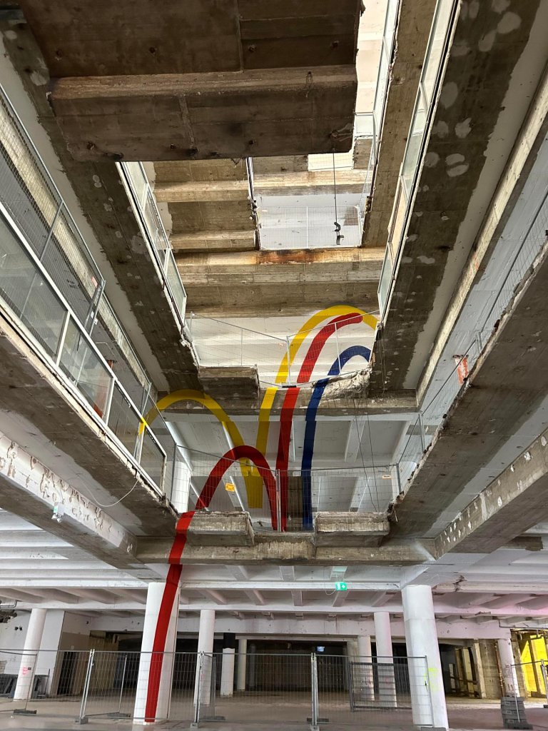 View into a gutted stairwell of a former department store.