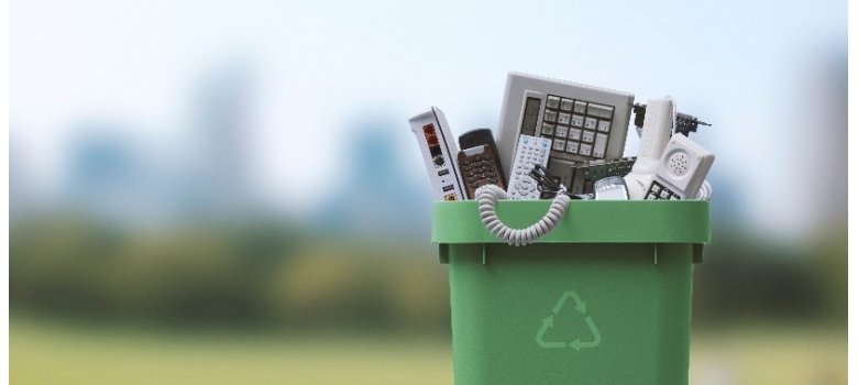 Electronic waste in green garbage can