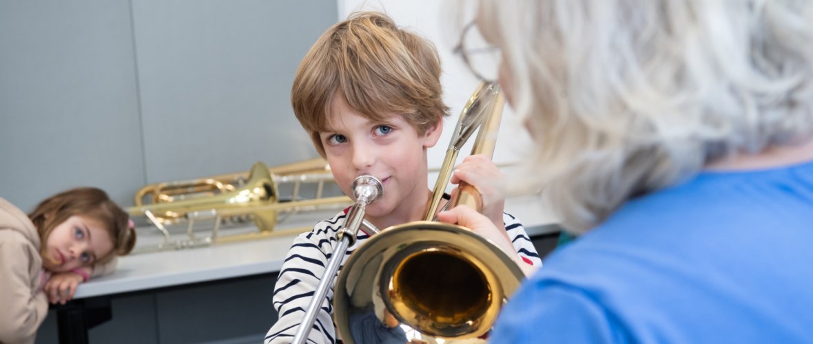 un garçon prend des cours de trombone