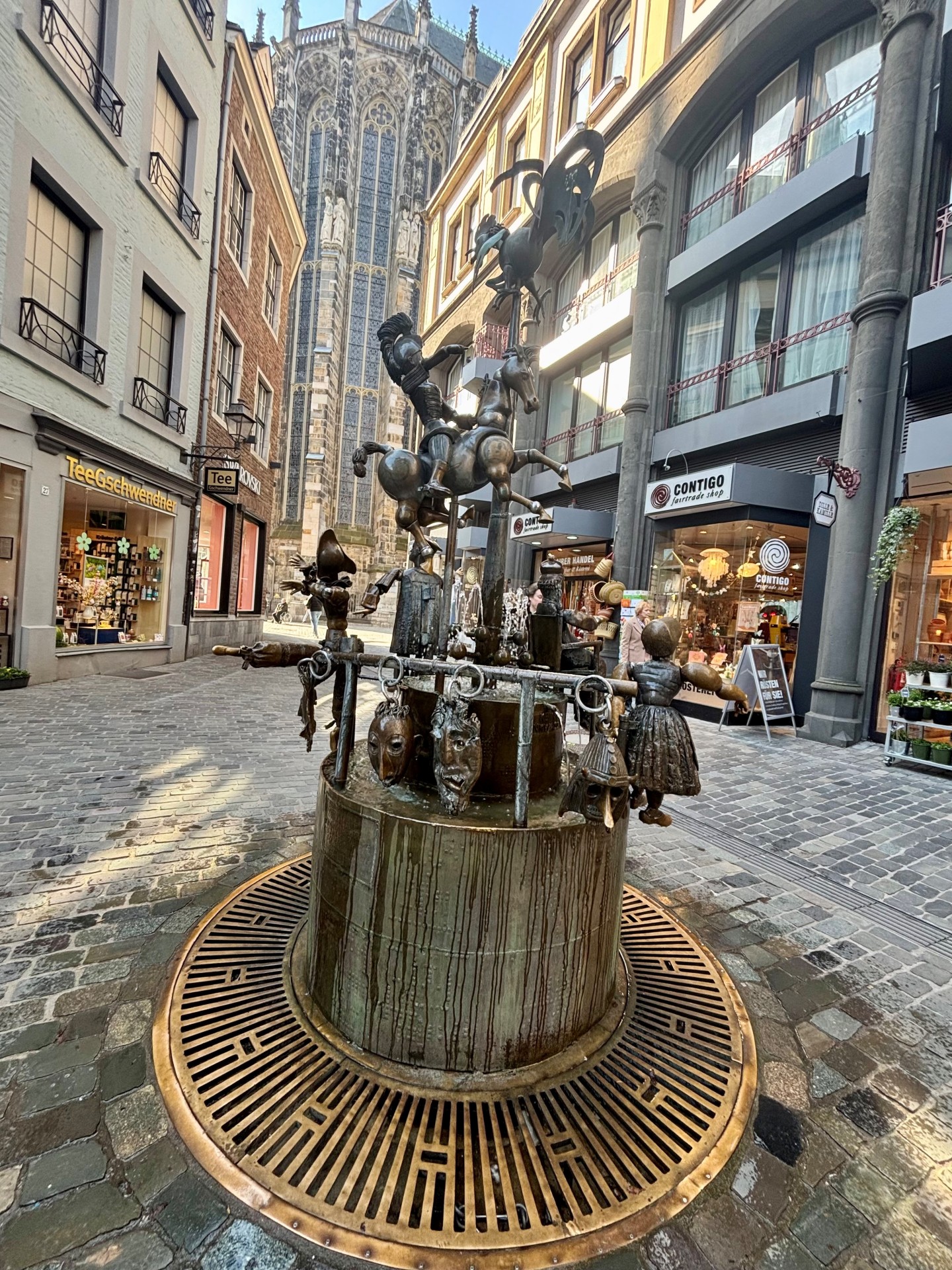 De poppenfontein in het centrum van de oude stad van Aken. Op de achtergrond is de koorhal van de kathedraal te zien.