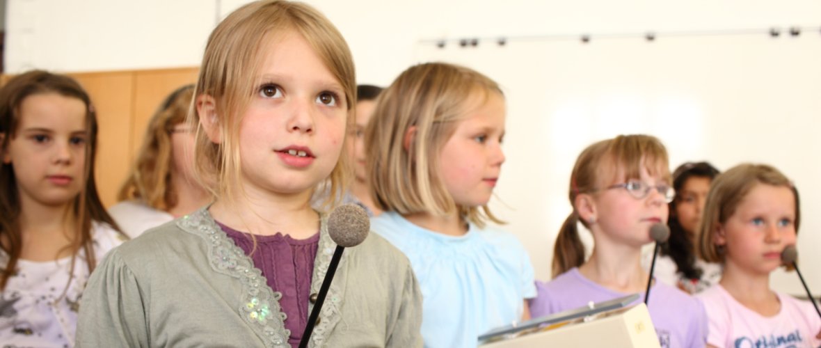 Eine Gruppe aus Kindern spielen jeweils auf einem Xylophon