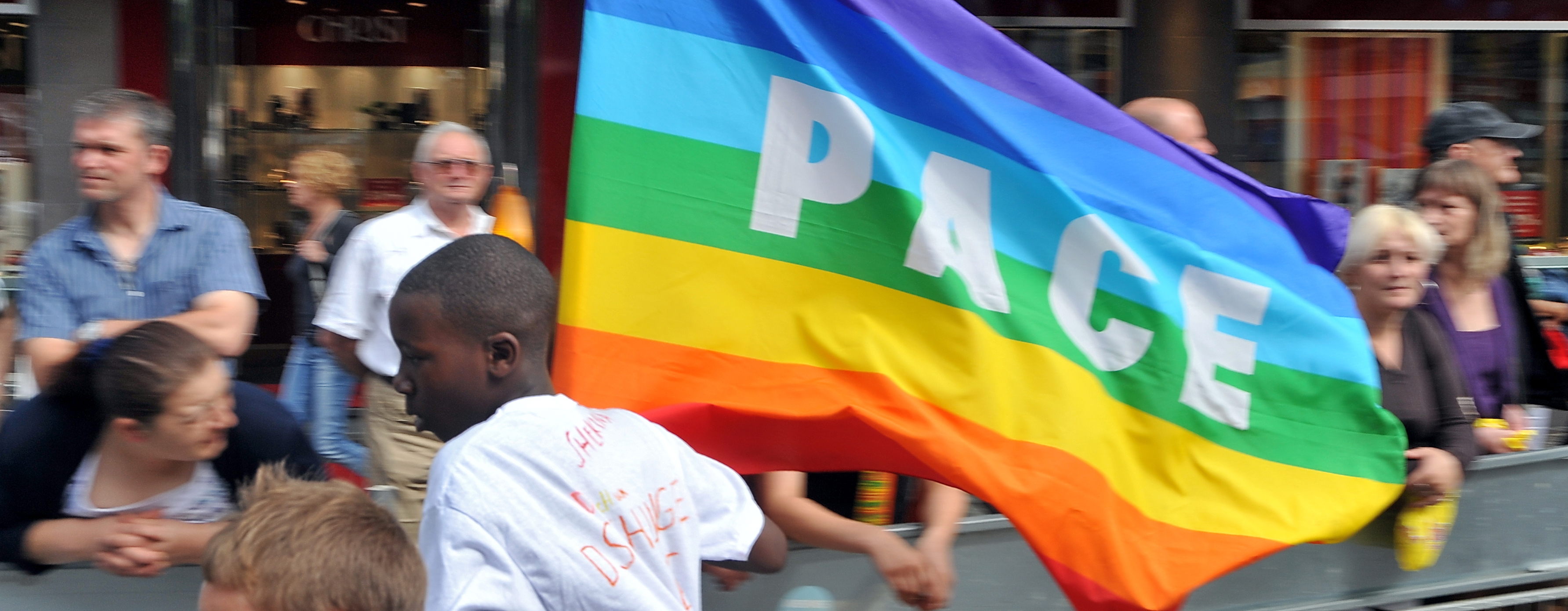 Jugendlicher trägt die Fahne der internationalen Friedensbewegung PACE beim Aachener Friedenslauf