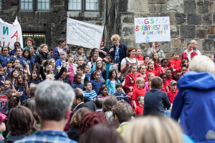 Singende Menschen auf der Rathaustreppe
