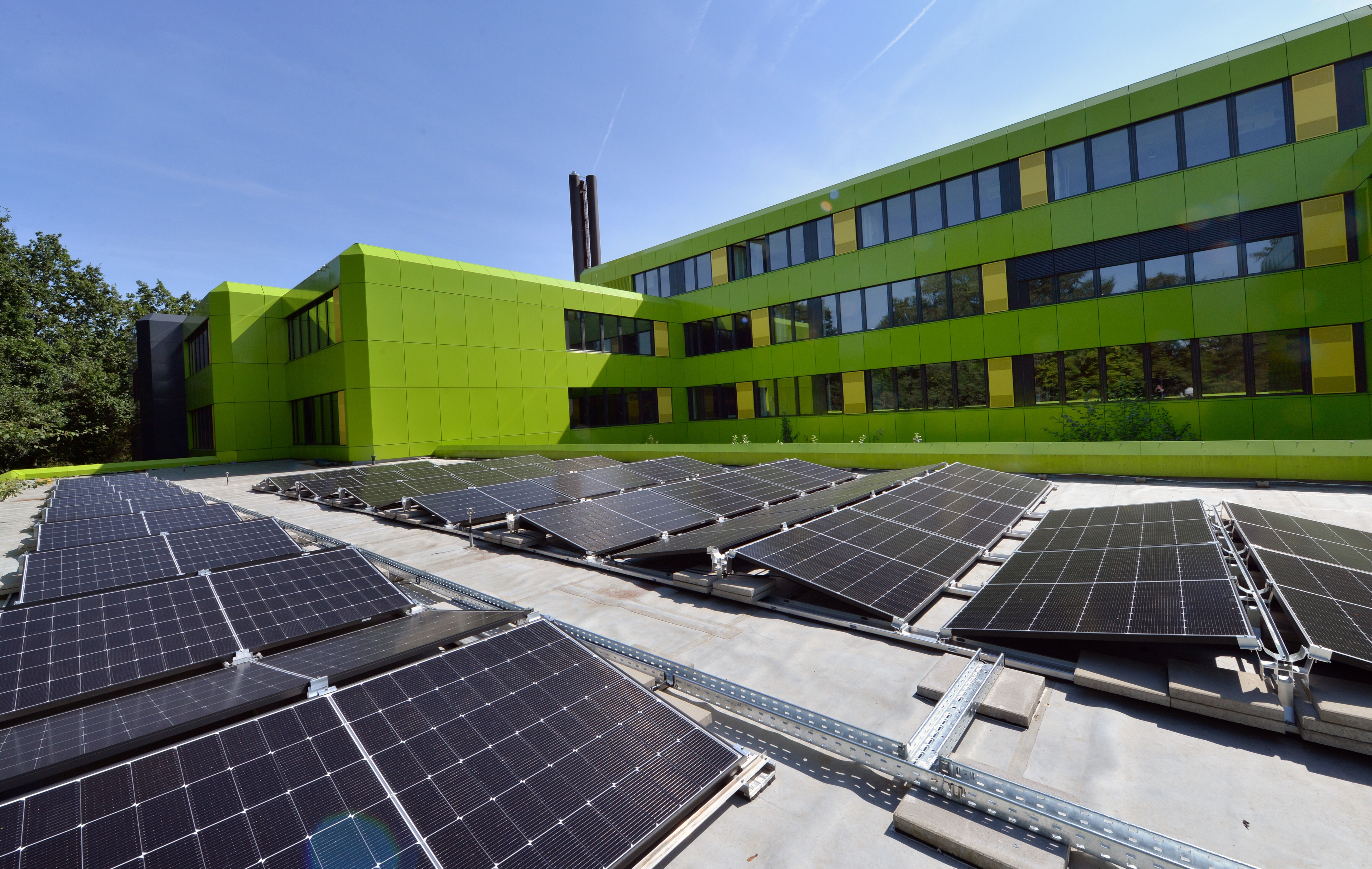 Große Solaranlage auf einem Aachener Schuldach im Sonnenschein.
